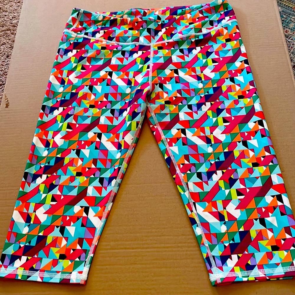 Fun, colorful, geometric print capri length athletic leggings.